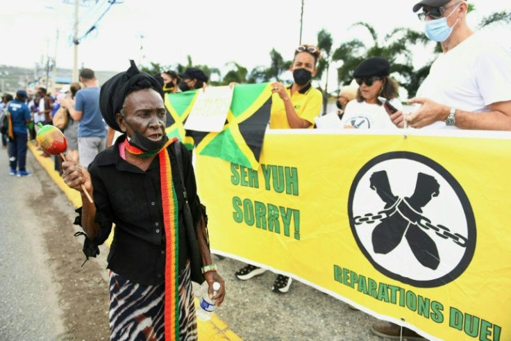 People calling for slavery reparations protest outside the British High Commission ahead of the visit of the Duke and Duchess of Cambridge in Kingston, Jamaica on March 22, 2022