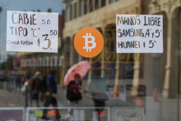A Bitcoin sign is displayed outside a store where the cryptocurrency is accepted as a payment method in San Salvador, El Salvador, February 1, 2022. 