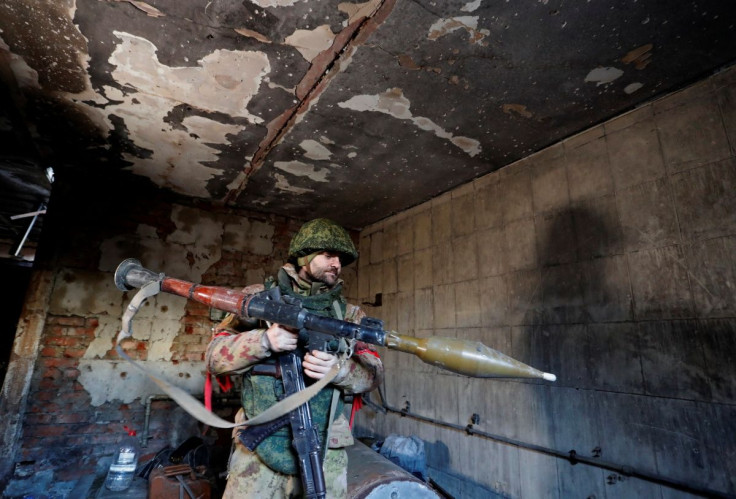 A service member of pro-Russian troops checks weapons inside a building, which according to the military, was previously a fighting position of Ukrainian armed forces, during Ukraine-Russia conflict in the town of Marinka, in the Donetsk Region, Ukraine M