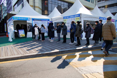 People wait in line to undergo the coronavirus disease (COVID-19) test at a testing site which is temporarily set up at a public health center in Seoul, South Korea, February 24, 2022. 