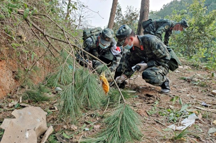 Firefighters, police and volunteers have scoured the rugged terrain near Wuzhou in southern China for signs of those onboard the ill-fated flight MU5735