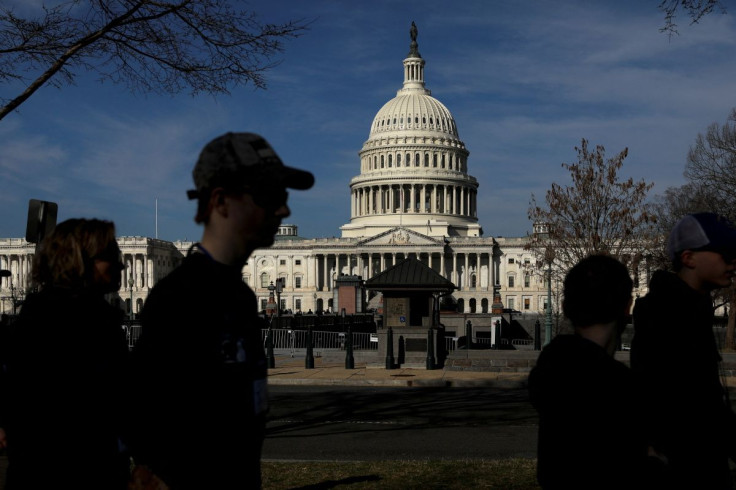 Pedestrians walk by the United States Capitol building in Washington, U.S. March 15, 2022.