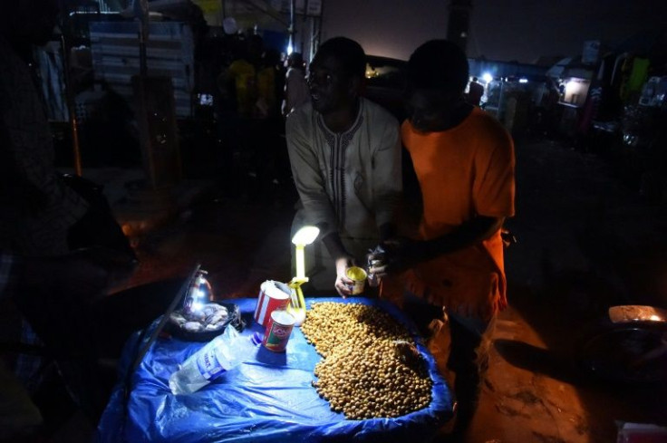 Tigernuts for sale by torchlight at a market without electricity