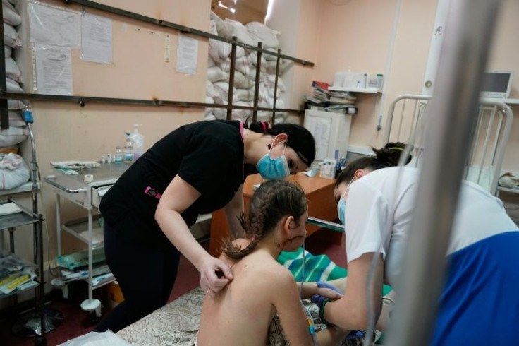 Nurses at the Zaporizhzhia Children's Hospital tend to Milena, a 13 year-old girl hit by a bullet as she was evacuating from Mariupol with her family