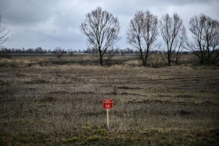 A sign reading 'Danger mines' in a field northeast of Ukraine's capital Kyiv, where local people normally grow wheat and other crops