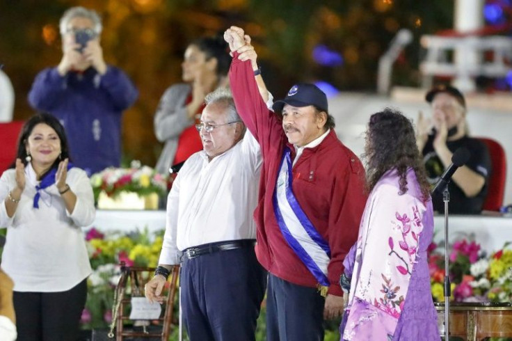 Nicaraguan President Daniel Ortega (C) is sworn in as president for a fourth straight term next to his wife and vice-president Rosario Murillo (R), during the inauguration ceremony in Managua in January 2022