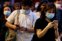 People wear face masks during the outbreak of coronavirus disease (COVID-19) in Singapore, April 3, 2020. 