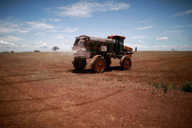 An agricultural worker drives a tractor spreading fertilizer in a soybean field, near Brasilia, Brazil February 15, 2022. Picture taken February 15, 2022.