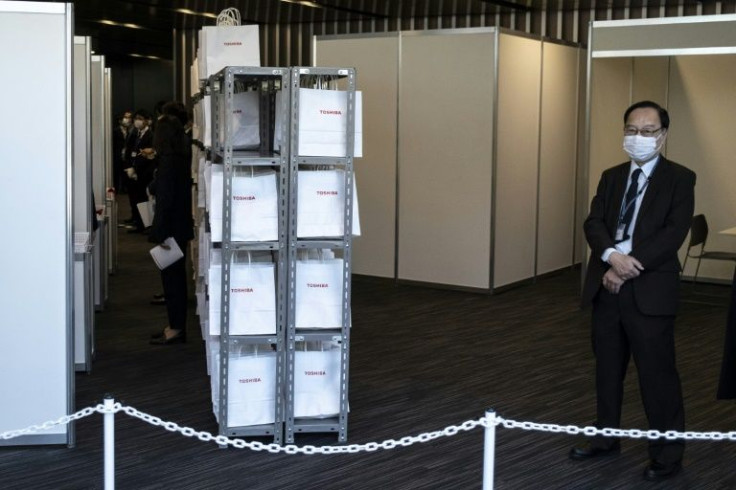 Staff members wait for shareholders to arrive for a meeting of Toshiba in Tokyo