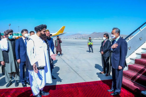 Afghan Foreign Minister Amir Khan Muttaqi greeting China's Foreign Minister Wang Yi at  Kabul Airport