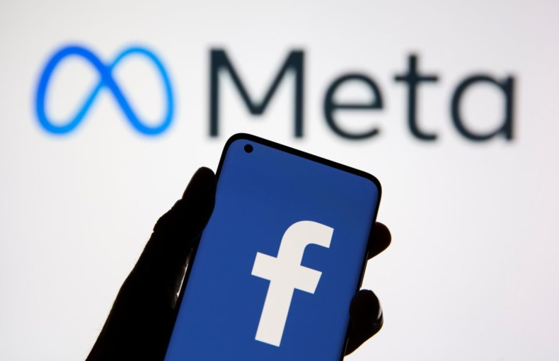 A smartphone with Facebook's logo is seen in front of displayed Facebook's new rebrand logo Meta in this illustration taken October 28, 2021. 