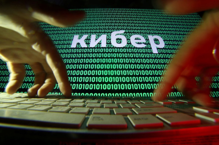 Hands are seen on a keyboard in front of a displayed cyber code in this picture illustration taken October 4, 2018. 
