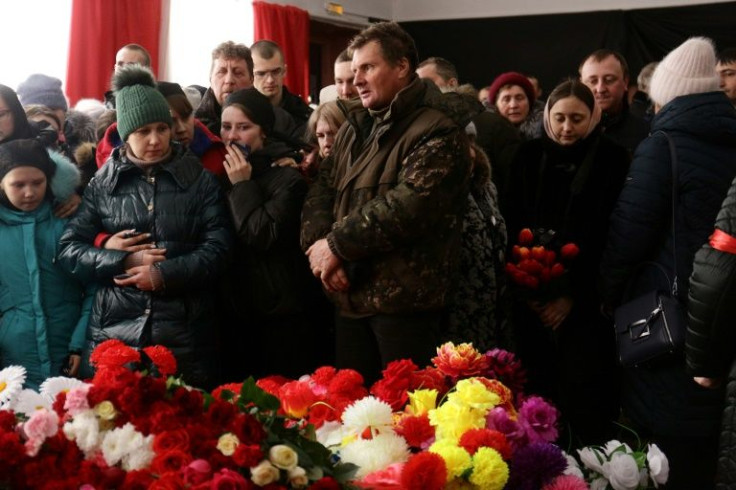 Carrying flowers and wreaths, mourners filed into a local community centre, some of them in tears