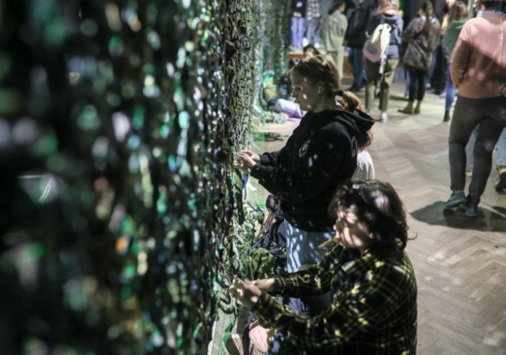 Volunteers stitching camouflage nets for the war effort dwindle every day as Lviv settles into a new rhythm of living
