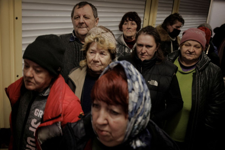 People who are sheltering in a metro station in northern Kharkiv stand in line to receive food from volunteers as Russia's attack on Ukraine continues, Ukraine, March 24, 2022.