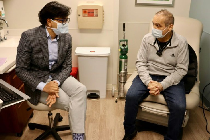 Albert Khoury (R) speaks about his new lungs with surgeon Ankit Bharat in Chicago in January 2022, in a handout image courtesy of Northwestern Medicine