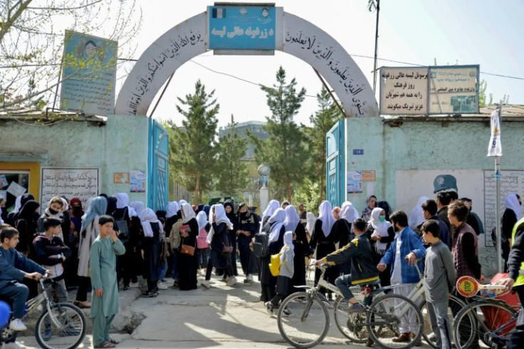 Afghan girls leave their school following the Taliban's order of closure just hours after reopening in Kabul on March 23, 2022