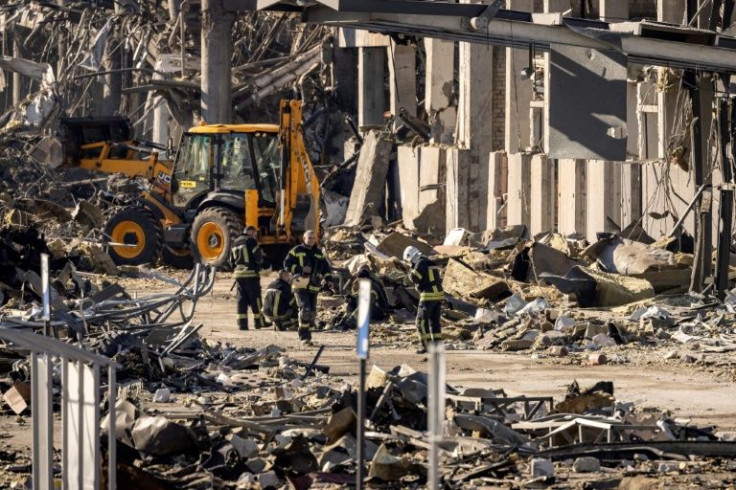 Ukrainian firefighters work amid the rubble in the northwest of the Ukranian capital Kyiv