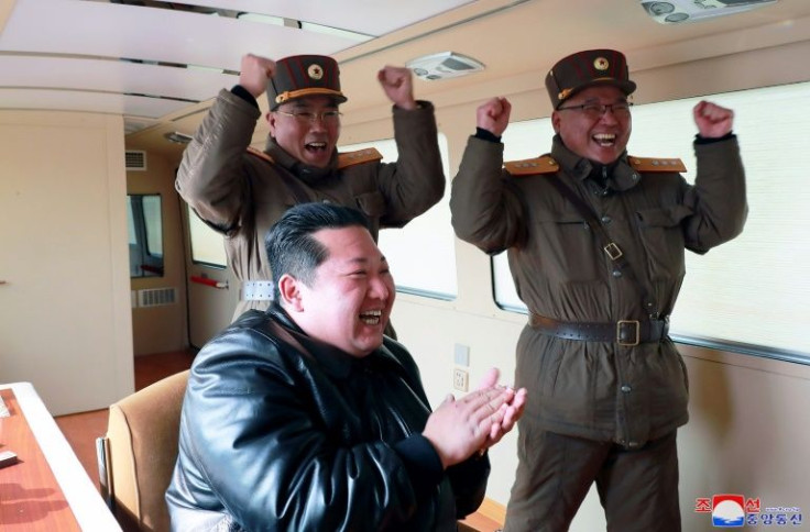 State media showed Kim cheering and celebrating the test-launch with uniformed military top brass
