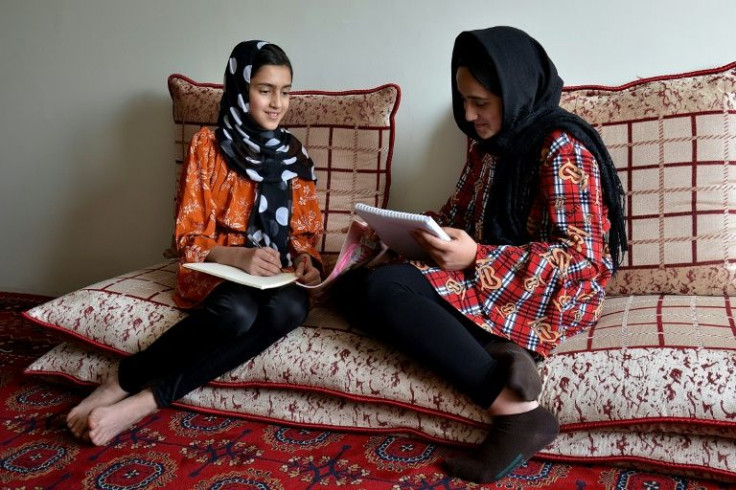Malahat Haidari (L) and her sister Adeeba Haidari study at home in Kabul