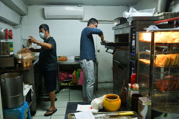 Lin Jih-shou and his son prepare food for customers at their breakfast joint in Dongyin, Taiwan, March 17, 2022. Photo taken March 17, 2022.