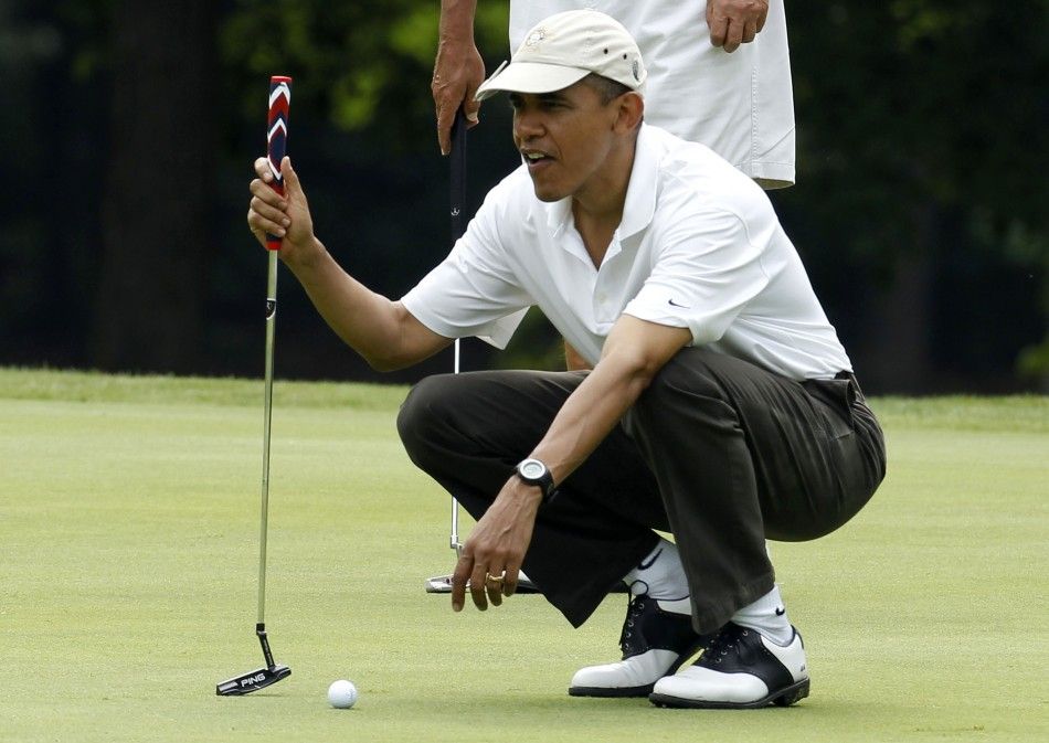U.S. President Barack Obama lines up a putt