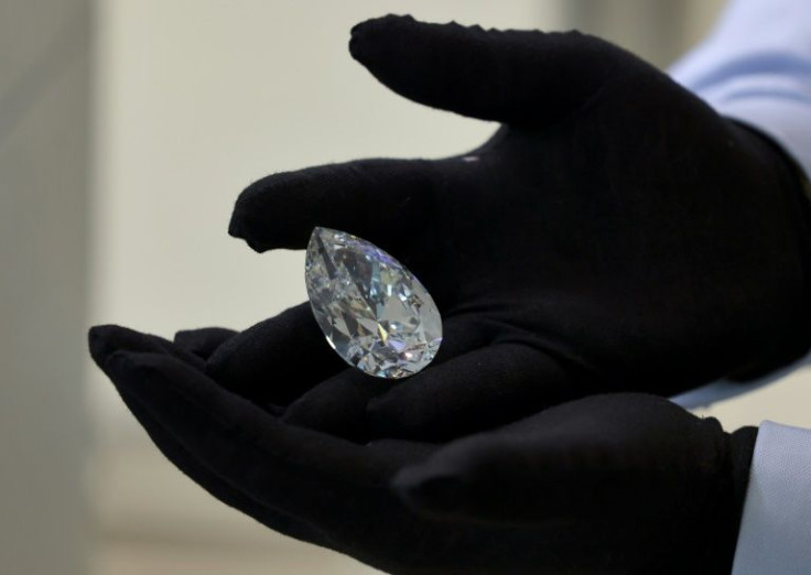 A Christie's auction house staff member displays the giant diamond nicknamed "The Rock", in Dubai