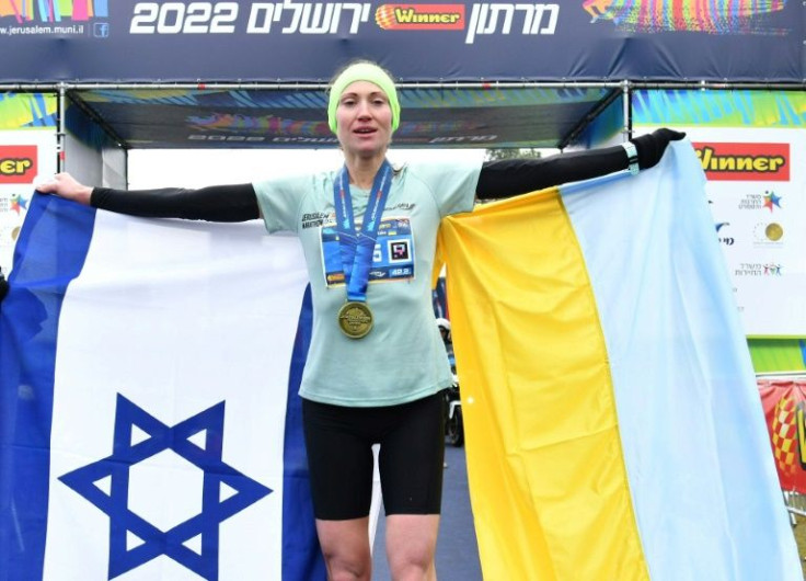 Ukrainian athlete Valentyna Veretska holds the Israeli and Ukranian flags after winning the Jerusalem marathon