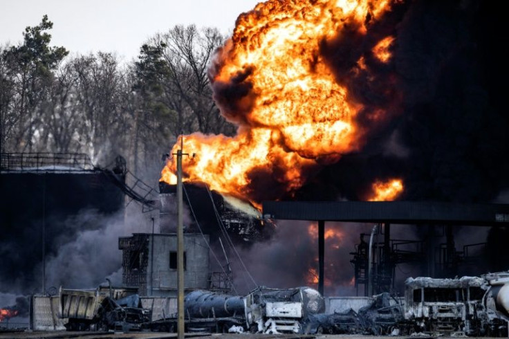 Fireballs still leapt from the charred wreckage of a fuel storage site a day after Russia attacked it