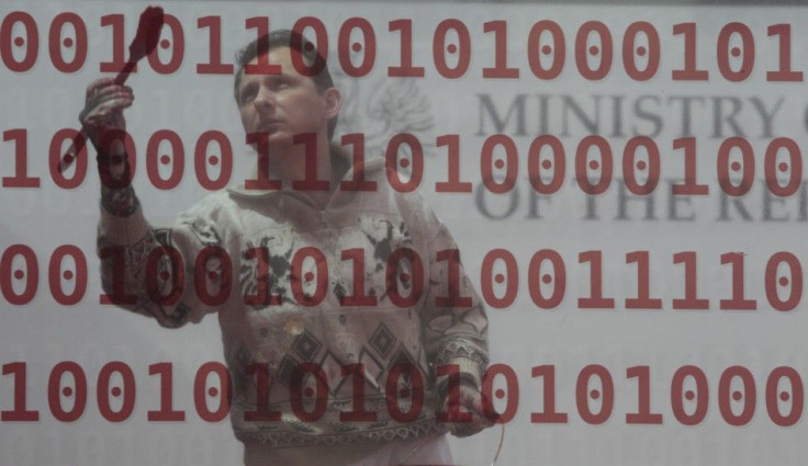 Man works at exhibition stand at CeBIT computer fair in Hanover