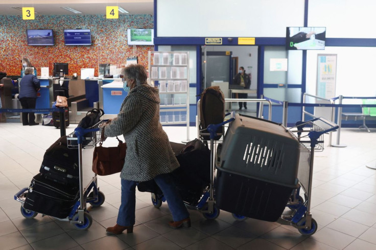 People check in at an airport to leave Sao Jorge island on the last commercial flight of the day, amid small earthquakes recorded in the area, in Velas, Azores, Portugal, March 26, 2022.