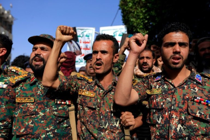 Soldiers loyal to Yemen's Huthi rebels join a rally in the rebel-held capital Sanaa marking the seventh anniversary of a Saudi-led coalition's military intervention in the country's devastating civil war