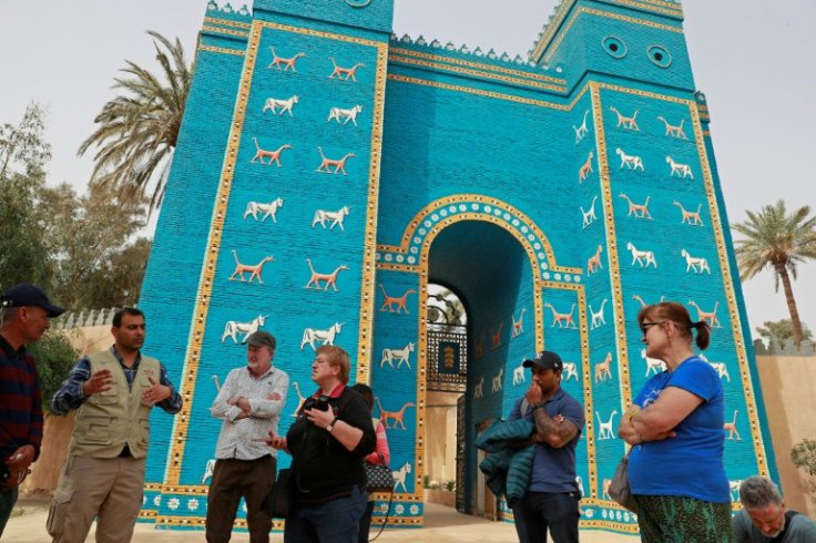 Foreign tourists visit the Ishtar Gate in the ancient city of Babylon, some 100 km south of the Iraqi capital Baghdad