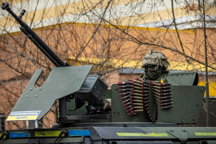 A Ukrainian soldier sits in an armored vehicle in the suburbs of Kyiv