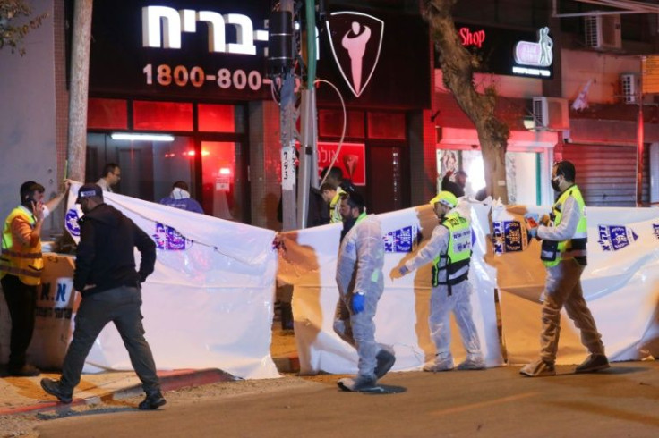 Israeli security forces gather at the site of an attack that left two Israeli police dead in the northern city of Hadera