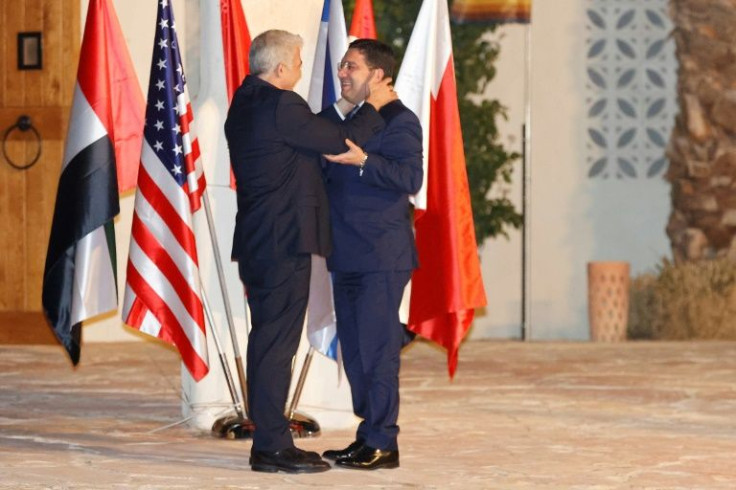 Israelâs Foreign Minister Yair Lapid (L) welcomes Morocco's Foreign Minister Nasser Bourita upon his arrival for a meeting in the southern Negev desert