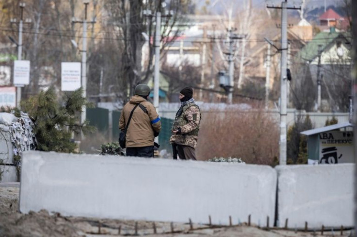 Volunteers man a checkpoint in Stoyanka where Russian snipers are active