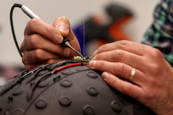 A worker at the Israeli startup Brain.Space builds an electroencephalogram (EEG) enabled helmet, due to be used in an experiment on the impact of a microgravity environment on the brain activity of astronauts, in Tel Aviv, Israel, March 23, 2022. Picture