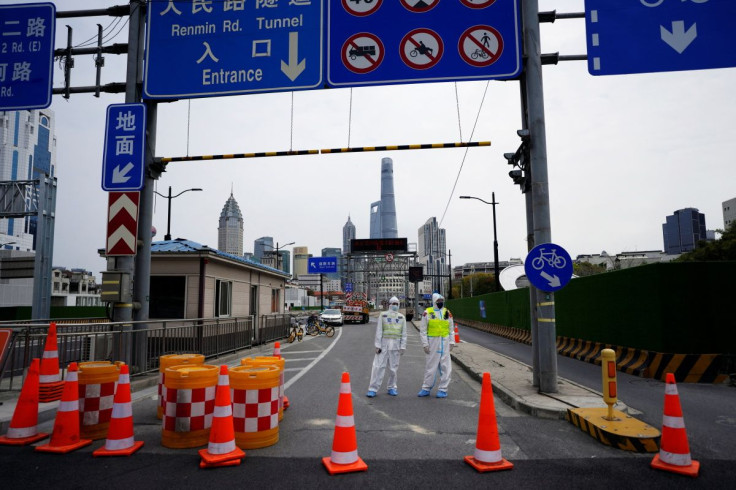 Police officers in protective suits keep watch at an entrance to a tunnel leading to the Pudong area across the Huangpu river, after traffic restrictions amid the lockdown to contain the spread of the coronavirus disease (COVID-19) in Shanghai, China Marc
