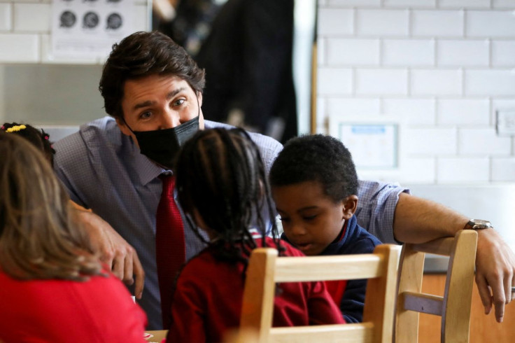 Canadian Prime Minister Justin Trudeau speaks with kids before announcing a new child care deal with Ontario Premier Doug Ford in Brampton Ontario, Canada March 28, 2022. 