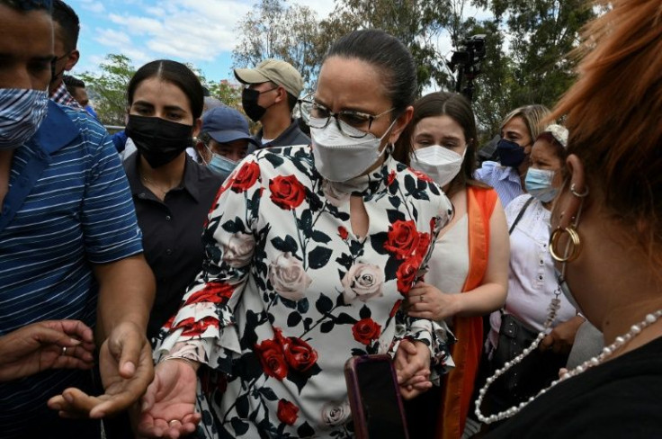 Juan Orlando Hernandez´s wife, Ana Garcia, prays outside the Supreme Court of Justice as she waits for its decision on whether or not to extradite her husband to the US