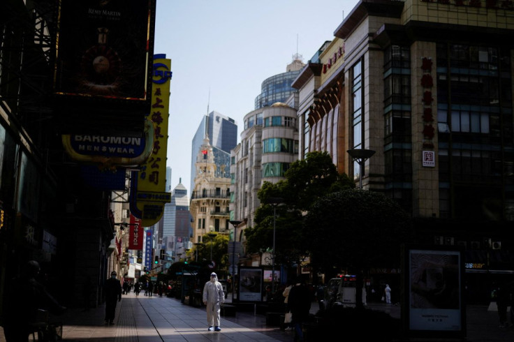 A security guard in personal protective equipment (PPE) walks at a main shopping area following the coronavirus disease (COVID-19) outbreak in Shanghai, China March 29, 2022. 