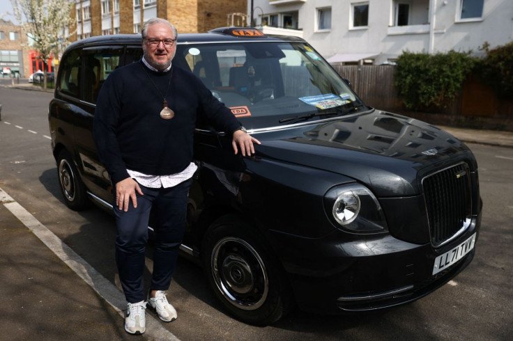 London black cab driver Matt Westfall, 52, poses for a photo during a Reuters interview in London, Britain, March 28, 2022.