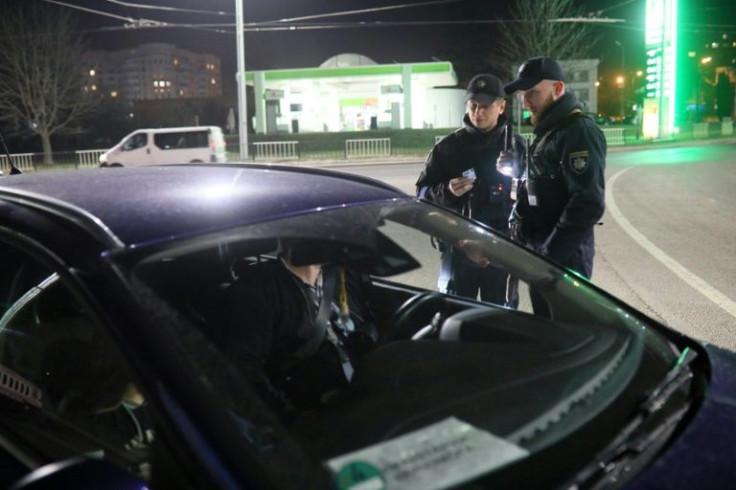 Ukrainian policemen are responsible for enforcing nighttime curfews in many cities