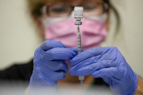 A nurses fills up syringes for patients as they receive their coronavirus disease (COVID-19) booster vaccination during a Pfizer-BioNTech vaccination clinic in Southfield, Michigan, U.S., September 29, 2021.  