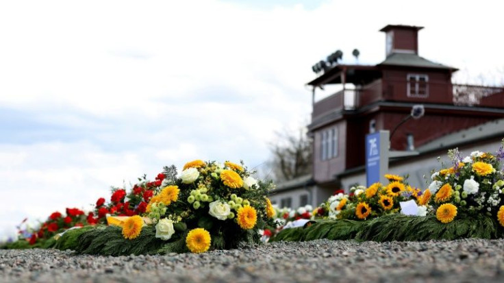 Wreaths of flowers lay in front of the main gate at the memorial site of the former Nazi concentration camp Buchenwald near Weimar, eastern Germany, on April 11, 2021, during commemorations marking the 76th anniversary of the camps' liberation