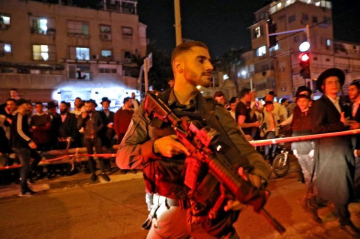 Israeli security forces gather at the scene of a shooting attack in the ultra-Orthodox town of Bnei Brak, near Tel Aviv -- attacks near Tel Aviv on Tuesday killed at least five people, emergency responders said