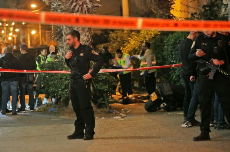 Israeli emergency personnel check the body of an alleged gunman at the scene of a shooting attack on March 29, 2022 in Bnei Brak