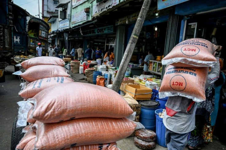 A labourer carries a sack of lentils at a market in Colombo