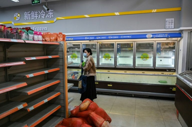 Shoppers among empty shelves in a supermarket before lockdown in Shanghai